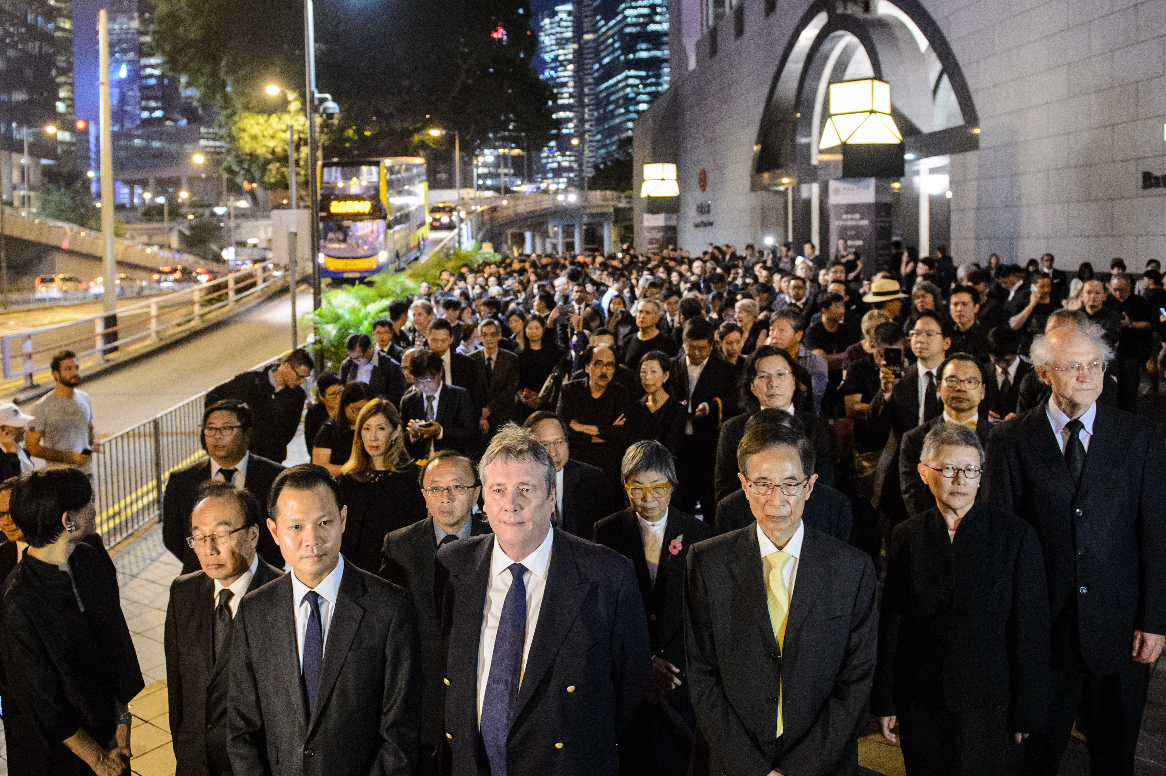 (Front L-R) Members from the legal sector, including former lawmaker Audrey Eu, lawmaker Dennis Kwok, senior counsel Graham Harris, former lawmaker Martin Lee, senior counsel Gladys Li and solicitor John Clancey, join other lawyers and law students in a silent march in protest at a ruling by China which effectively bars two pro-independence legislators from taking office in Hong Kong on November 8, 2016. Hundreds of lawyers and law students, all dressed in black, marched silently through Hong Kong on November 8 in protest at a ruling by China which effectively bars two pro-independence legislators from taking office. / AFP PHOTO / Anthony WALLACE