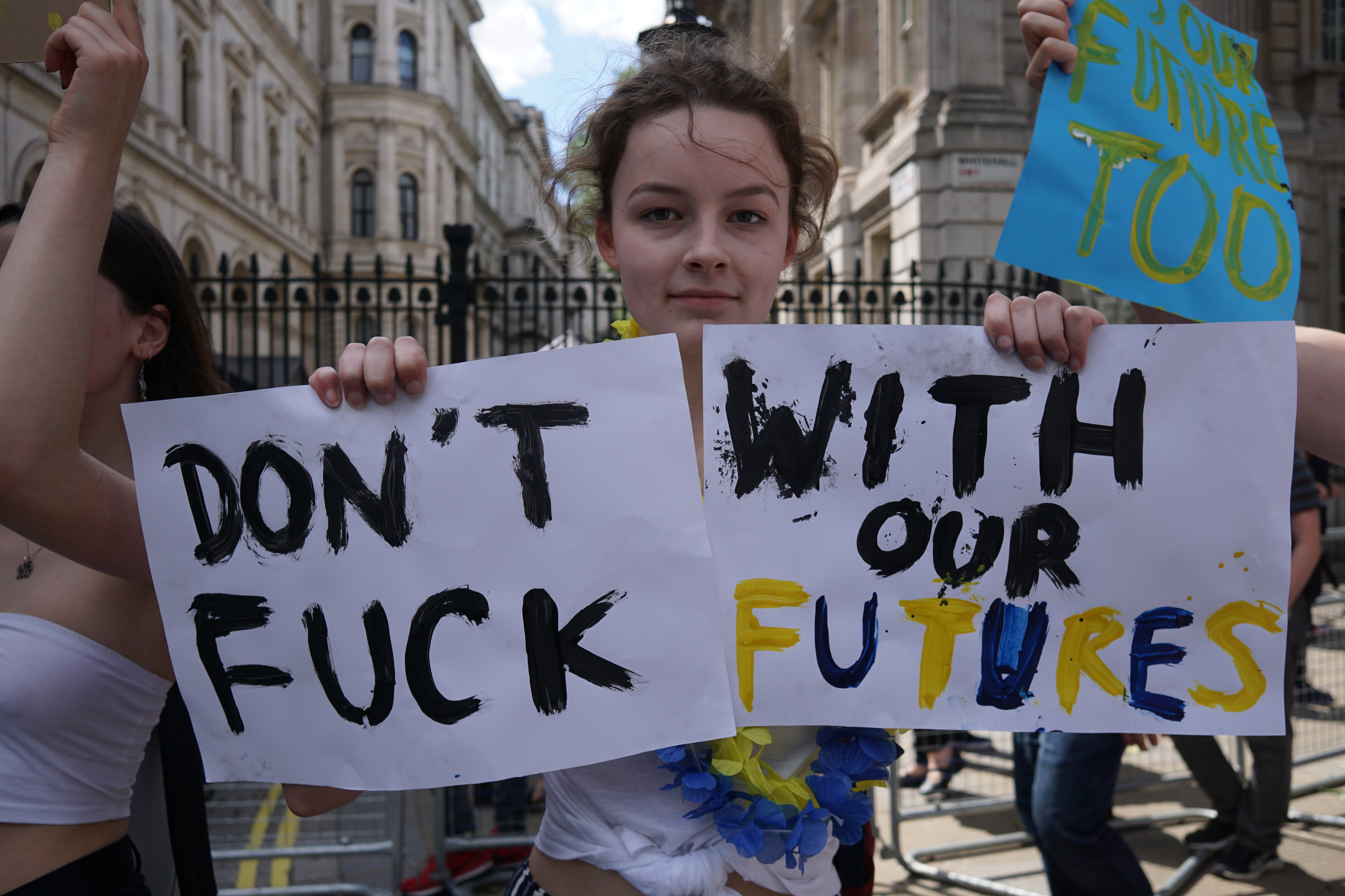 UNITED KINGDOM, London: A young woman holds placards as small group of teenagers protest against Brexit and demand the right to vote for 16 and 17 years old citizens, outside Downing Street, in London, on June 24, 2016, following Britain's referendum results to leave the European Union - See LI