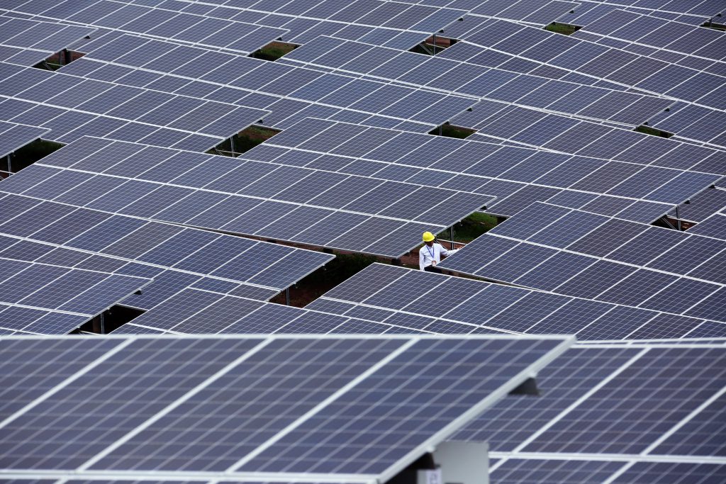 --FILE--A Chinese worker checks solar panels at a photovoltaic power station in Weining Yi, Hui and Miao Autonomous County, southwest China's Guizhou province, 30 June 2016. China's epic solar binge accelerated in the first six months of 2016, as the country added more than 20 gigawatts of new solar installations. That's nearly three times as much as the same period in 2015, and is more than the total installed capacity of all but Germany, Japan, and the United States. But signs are growing that the boom is starting to fade. Investment firm Macquarie Capital said in July that many of the solar farms built in 2016 were hastily completed to meet the deadline of July 1, when government subsidies for new solar were cut. Further cuts are expected in 2017 as the government tries to rein in runaway development. China now has around 63 gigawatts of solar power capacity, more than any other country. And wind, solar, nuclear, and hydro projects continue to be built out even though energy demand in China is nearly flat.