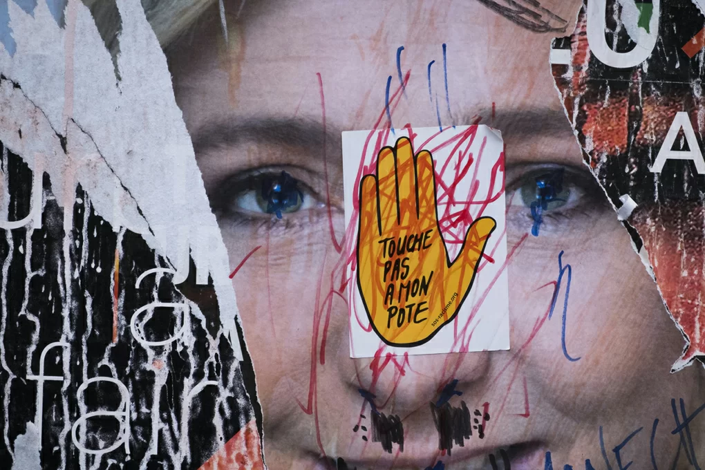A picture taken in Paris on May 2, 2017 shows a vandalised campaign poster of French presidential election candidate for the far-right Front National (FN) party Marine Le Pen ahead of the second and final round of the French presidential election on May 7. 
 / AFP PHOTO / JOEL SAGET
