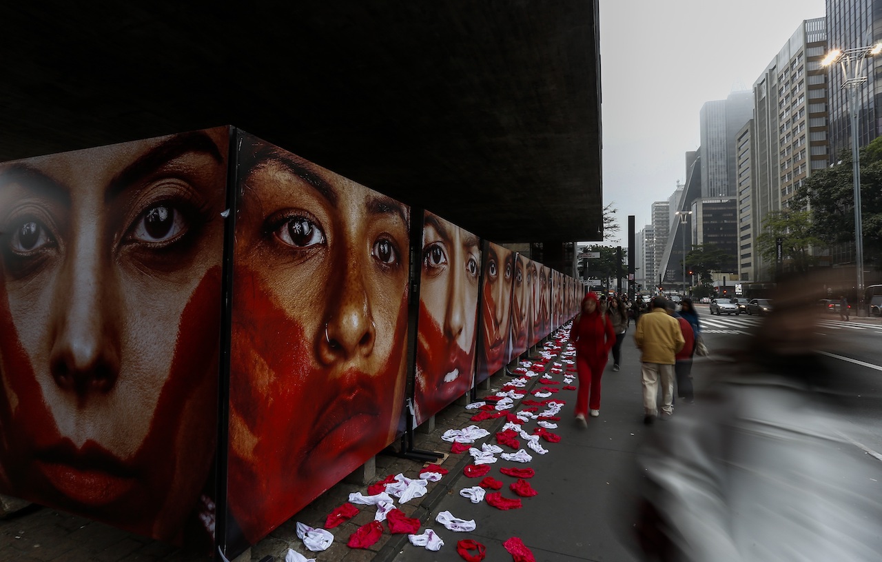 Members of the NGO Rio de Paz hold an exhibit demonstration against violence against women, displaying some 420 panties and portraits of bloodstained women, in Paulista Avenue in Sao Paulo, Brazil on June 10, 2016. According to the NGO some 50,000 women each year are sexually assaulted in Brazil. / AFP PHOTO / Miguel Schincariol
