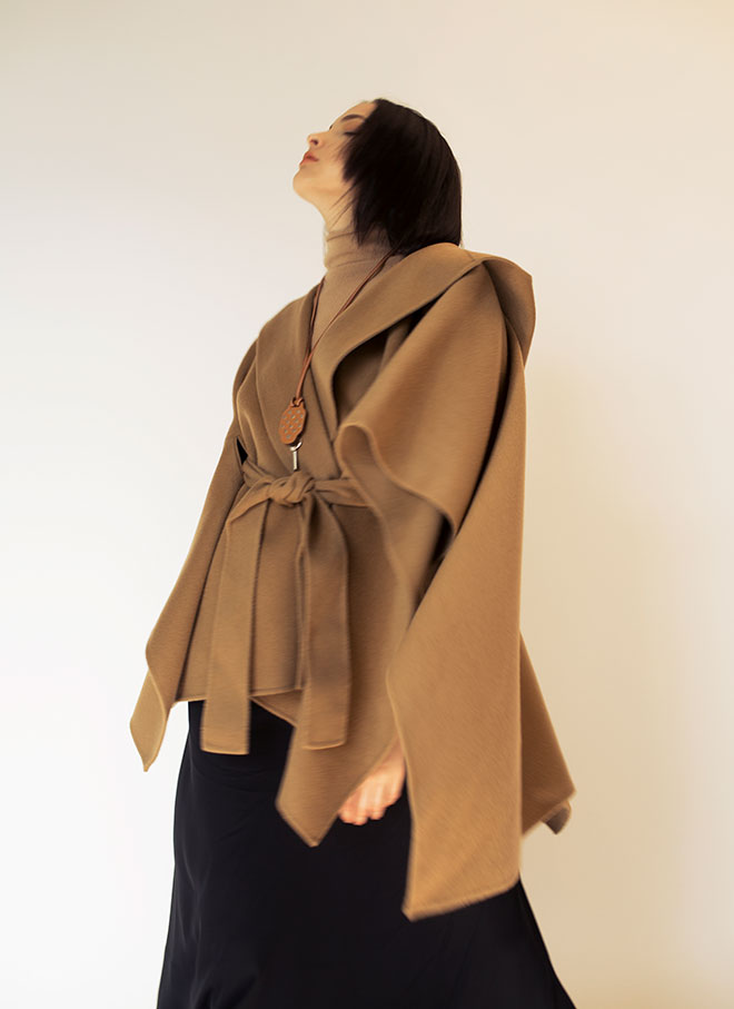 Cashmere top $3,300, silk skirt $3,900,  hooded cape $8,750 from Theory, necklace $5,800 from Hermès