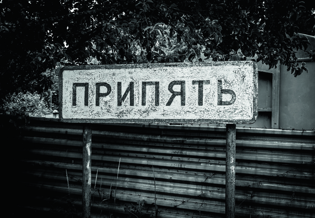 (EDITOR'S NOTE: Image was converted to black and white) A title of the abandoned city of Pripyat on a sign, near the Chernobyl nuclear power plant, Ukraine, on 7 June 2019. The Chernobyl Series (HBO) , which depicts the Chernobyl nuclear power disaster's aftermath, including the clean-up operation and subsequent inquiry, drives boom in tourists travelling to see the site of nuclear disaster. Tour agencies have reported up to a 40 per cent increase in bookings since the miniseries aired May 2019. On 2019 Ukraine marked the 33rd anniversary of Chernobyl nuclear disaster. The Chernobyl accident occurred on 26 April 1986 at the Chernobyl Nuclear Power Plant near the city of Pripyat, and regarded the biggest nuclear accident in the history. (Photo by STR/NurPhoto)