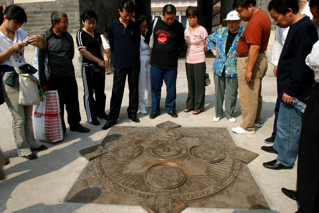 Locals and tourists look at Zero Point sign of China Highway of Highway China near the Zhengyangmen Gate on Tiananmen Square of Beijing, September 27, 2006 2 According to the Communication Ministry, the sign symbolizes the starting point of Chinese major highways and is now open to the public, along with the Zhengyangmen Gate after a year of renovation in Beijing