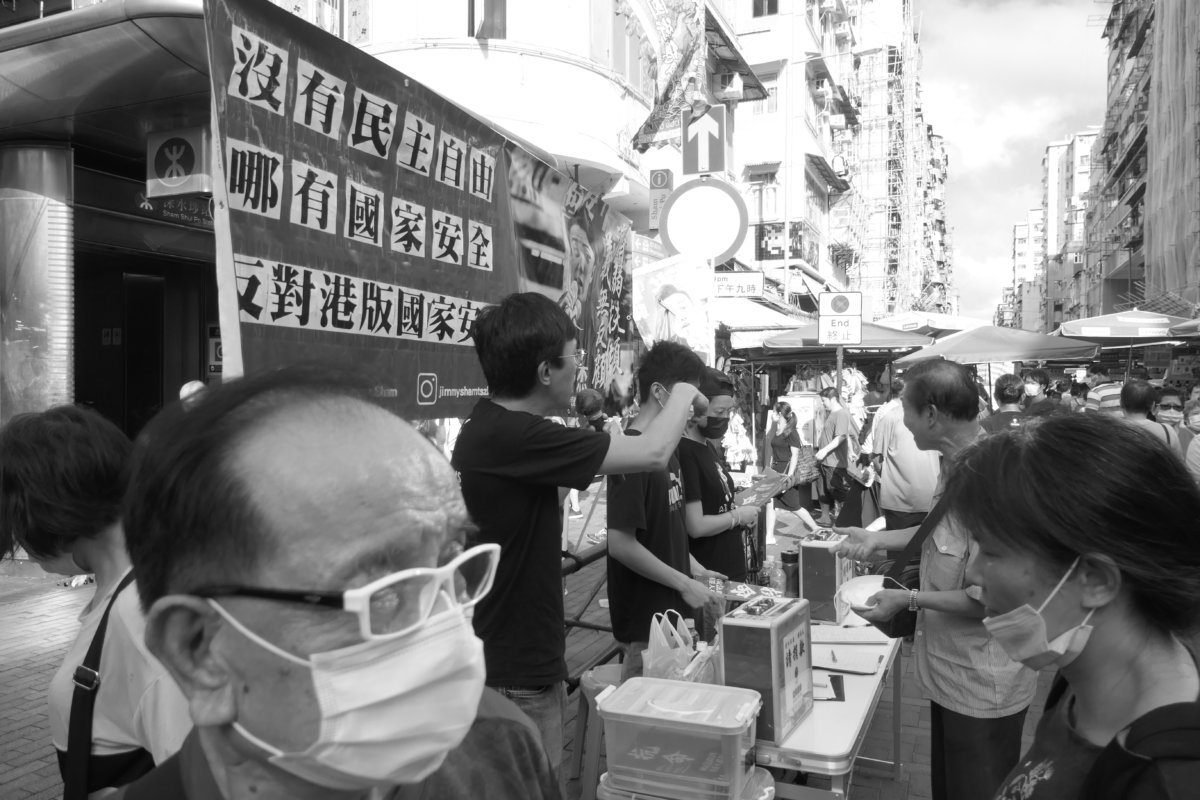 Street campaigning and watched by bystanders, Sham Shui Po, Kowloon, Hong Kong, 14 June 2020. (photograph: John Batten) 