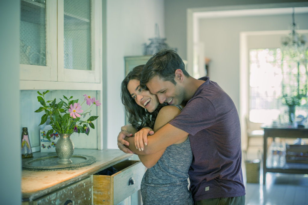 Couple embracing at home