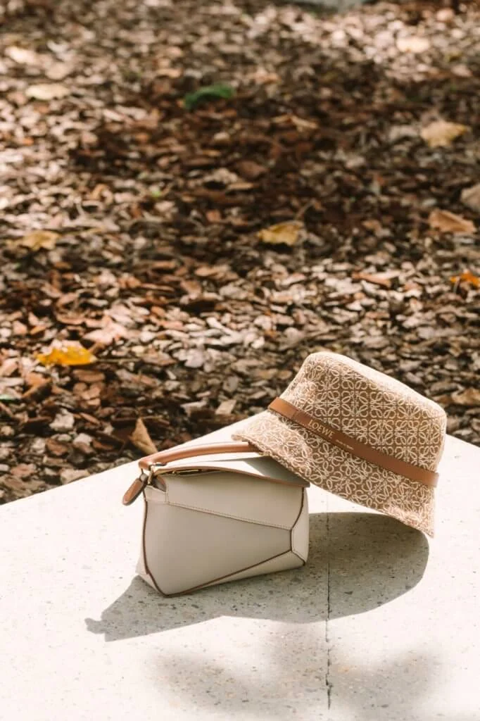 LOEWE PUZZLE EDGE MINI BAG $18,700 ANAGRAM BUCKET HAT $4,250 