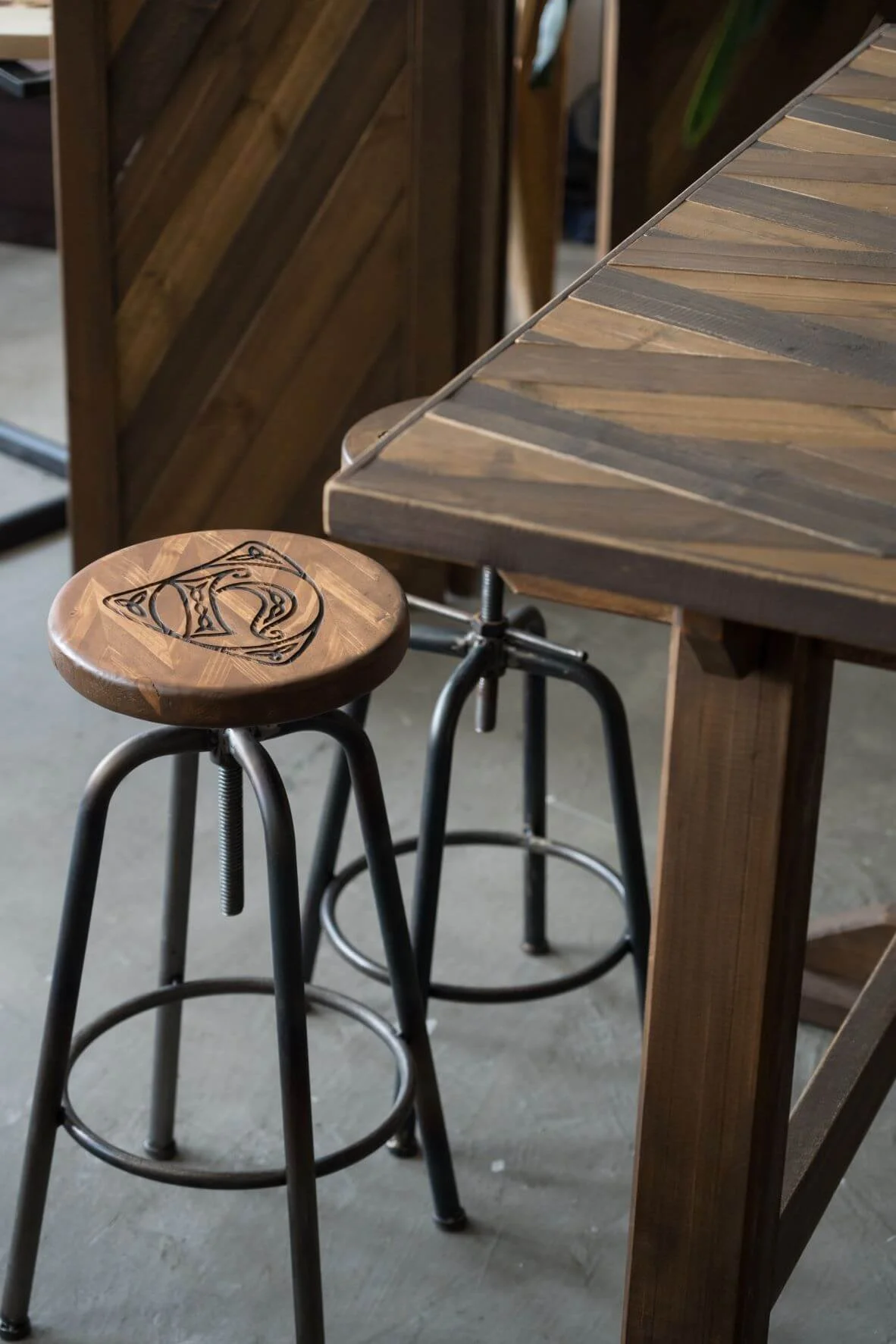 鐵椅腳配以品牌製作的木面，再加上雕刻的logo，造就出不同於傳統木工工藝的風格。