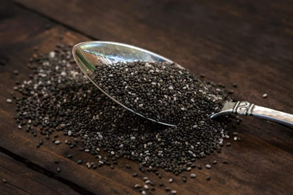 Spoonful of chia seeds (Salvia hispanica) on table