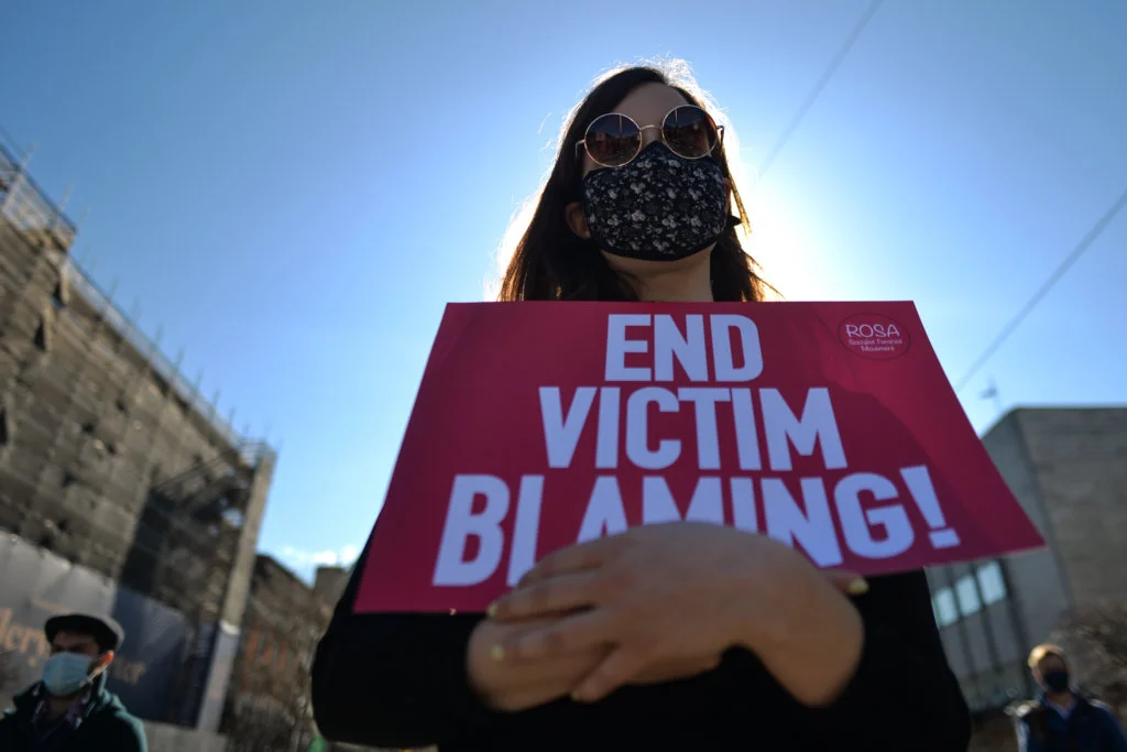 An activist holds a placard reading 'End Victim Blaming!' during a solidarity protest with women in the UK against gender-based violence seen on O'Connell Street in Dublin. 
The tragic killing of 33-year-old Sarah Everard in London sparked outrage among women in Britain, Ireland and across the world.
Activists demand further action to combat violence against women.
On Tuesday, 16 March 2021, in Dublin, Ireland. (Photo by Artur Widak/NurPhoto) (Photo by Artur Widak / NurPhoto / NurPhoto via AFP)