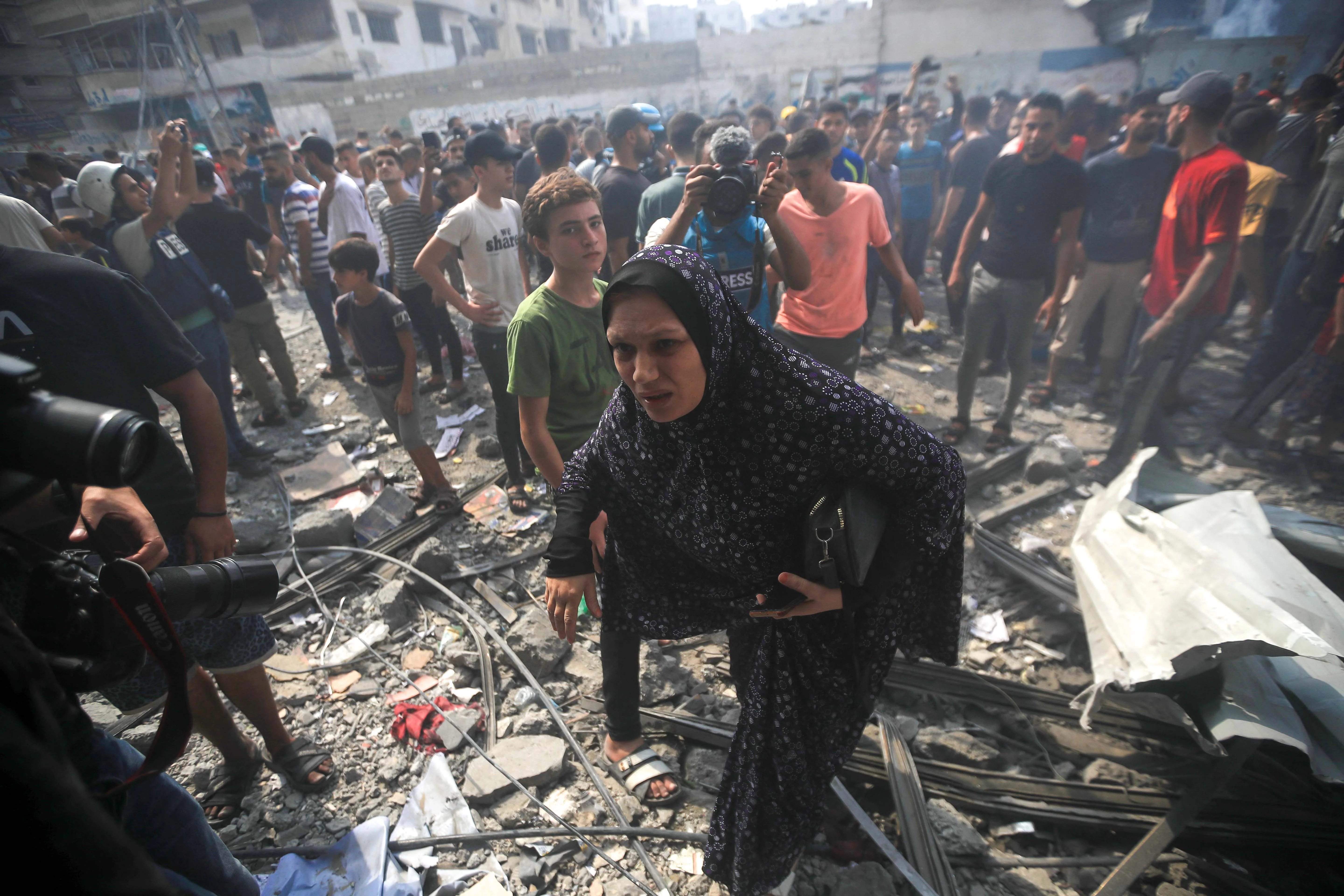巴勒斯坦人在空襲過後的廢墟之中尋找傷者與屍體（法新社圖片）