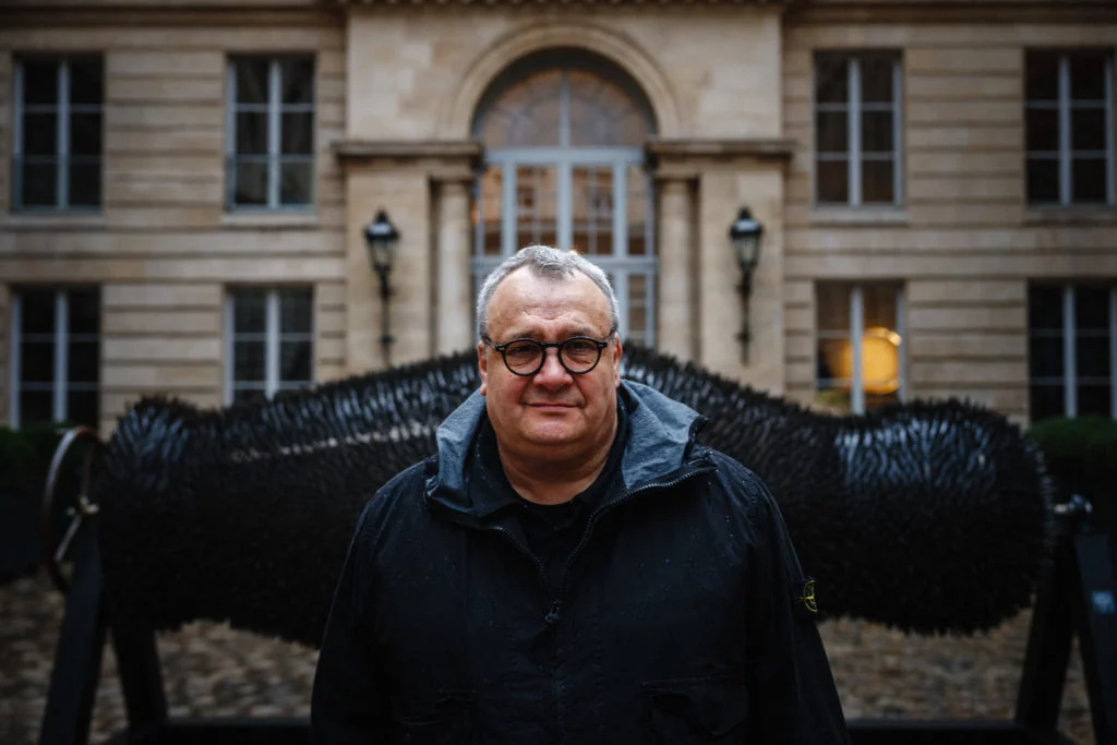Ukrainian artist Mikhail Reva poses next to his artwork "Russian souvenir" (Matryoshka) which is made from hundreds of empty bullets casings displayed at the Hotel de Talleyrand and George Marshall Center in Paris on, February 22, 2024. (Photo by Dimitar DILKOFF / AFP) / RESTRICTED TO EDITORIAL USE - MANDATORY MENTION OF THE ARTIST UPON PUBLICATION - TO ILLUSTRATE THE EVENT AS SPECIFIED IN THE CAPTION - RESTRICTED TO EDITORIAL USE - MANDATORY MENTION OF THE ARTIST UPON PUBLICATION - TO ILLUSTRATE THE EVENT AS SPECIFIED IN THE CAPTION /