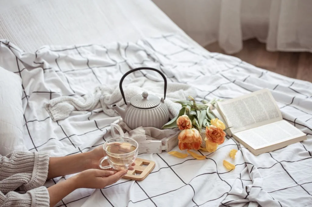 still-life-with-cup-tea-teapot-bouquet-tulips-book-bed
