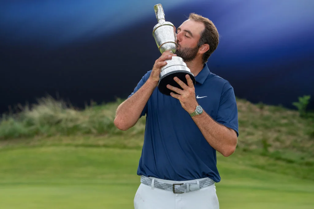 Scottie Scheffler (USA) holds the Claret Jug on the eighteenth green after winning The Open Championship 2025