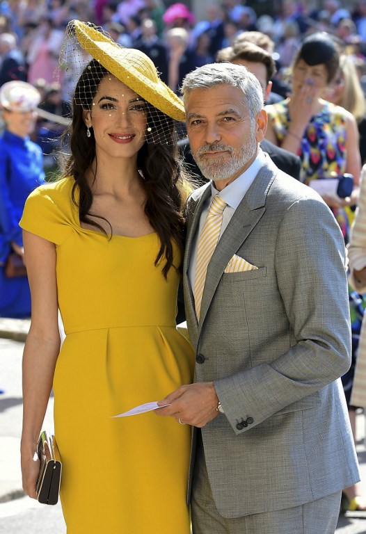 US actor George Clooney (R) and his wife British lawyer Amal Clooney (L) arrive for the wedding ceremony of Britain's Prince Harry, Duke of Sussex and US actress Meghan Markle at St George's Chapel, Windsor Castle, in Windsor, on May 19, 2018. / AFP PHOTO / POOL / Ian West