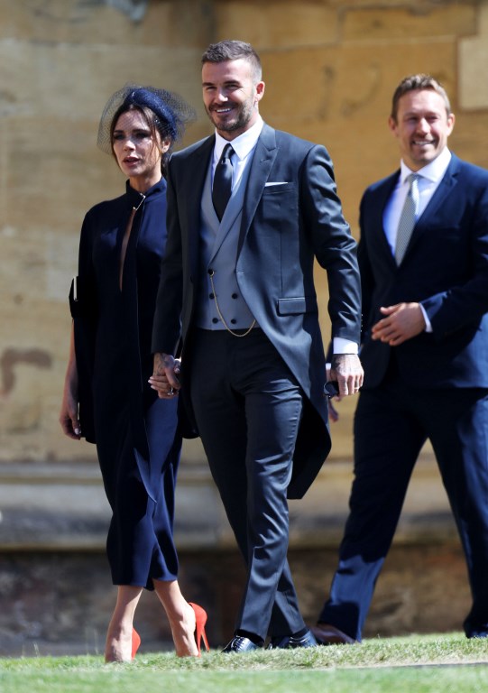 Former England footballer David Beckham (R) and his wife Victoria Beckham arrive for the wedding ceremony of Britain's Prince Harry, Duke of Sussex and US actress Meghan Markle at St George's Chapel, Windsor Castle, in Windsor, on May 19, 2018. / AFP PHOTO / POOL / Chris Jackson