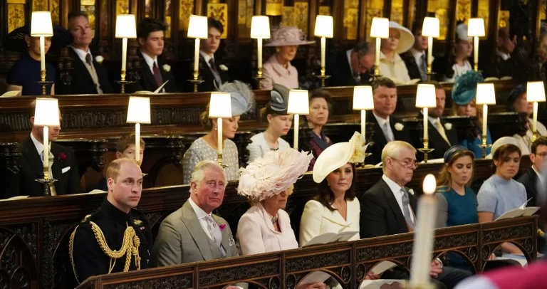 (Front row L-R) Britain's Prince William, Duke of Cambridge, Britain's Prince Charles, Prince of Wales, Britain's Camilla, Duchess of Cornwall, Britain's Catherine, Duchess of Cambridge, Britain's Prince Andrew, Duke of York, Britain's Princess Beatrice of York and Britain's Princess Eugenie of York wait in the chapel ahead of the wedding ceremony of Britain's Prince Harry, Duke of Sussex and US actress Meghan Markle in St George's Chapel, Windsor Castle, in Windsor, on May 19, 2018. / AFP PHOTO / POOL / Jonathan Brady