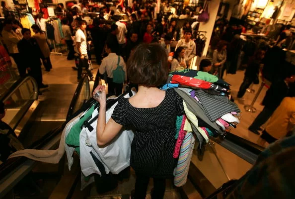 SHANGHAI, CHINA - APRIL 15: Customers shop at the newly opened Swedish giant H&M's first mainland China store on April 15, 2007 in Shanghai, China. About 1,400 H&M stores operate in 28 countries. (Photo by Cancan Chu/Getty Images)