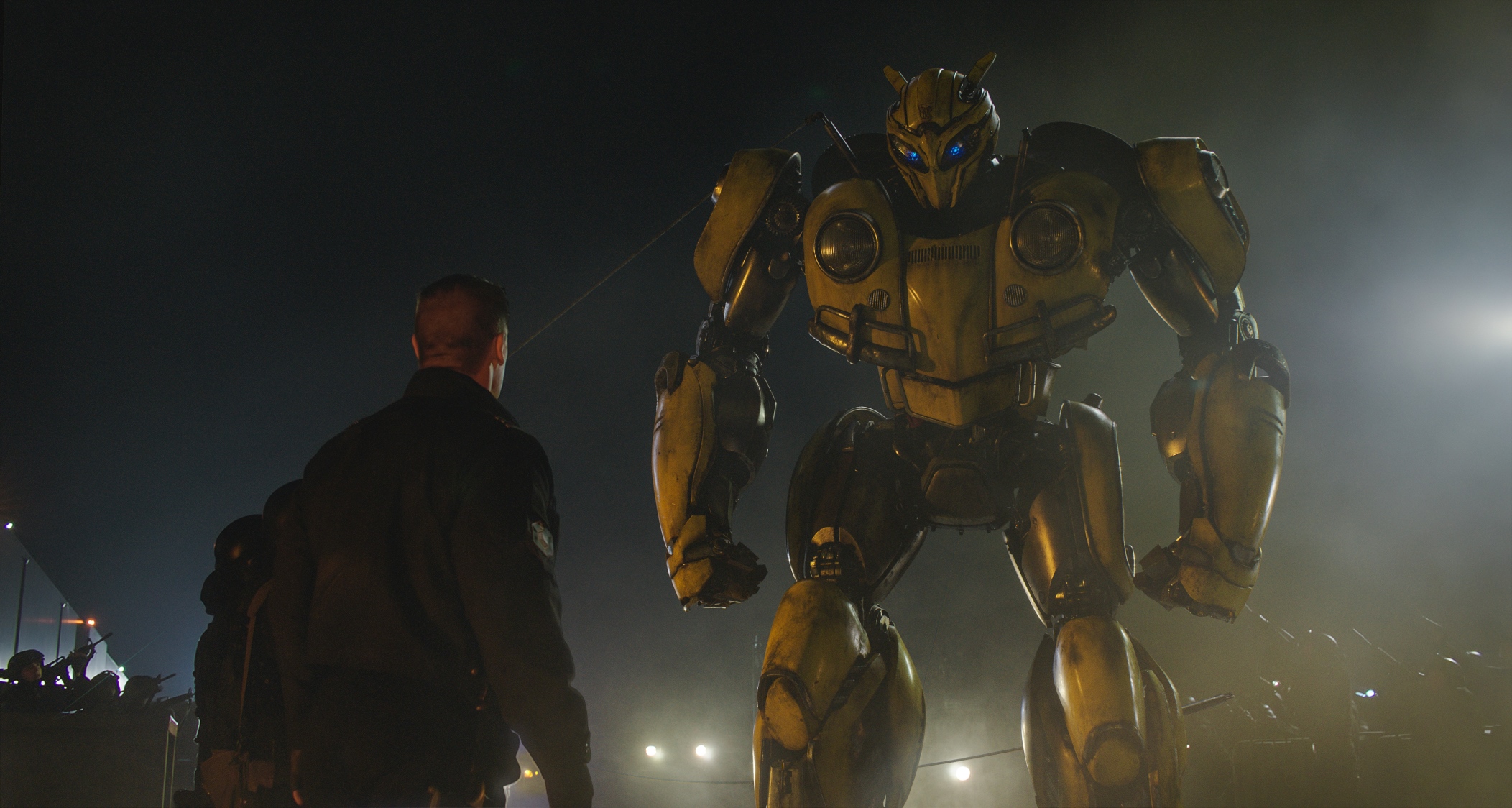 Left to right: John Cena as Agent Burns and Bumblebee in BUMBLEBEE from Paramount Pictures.